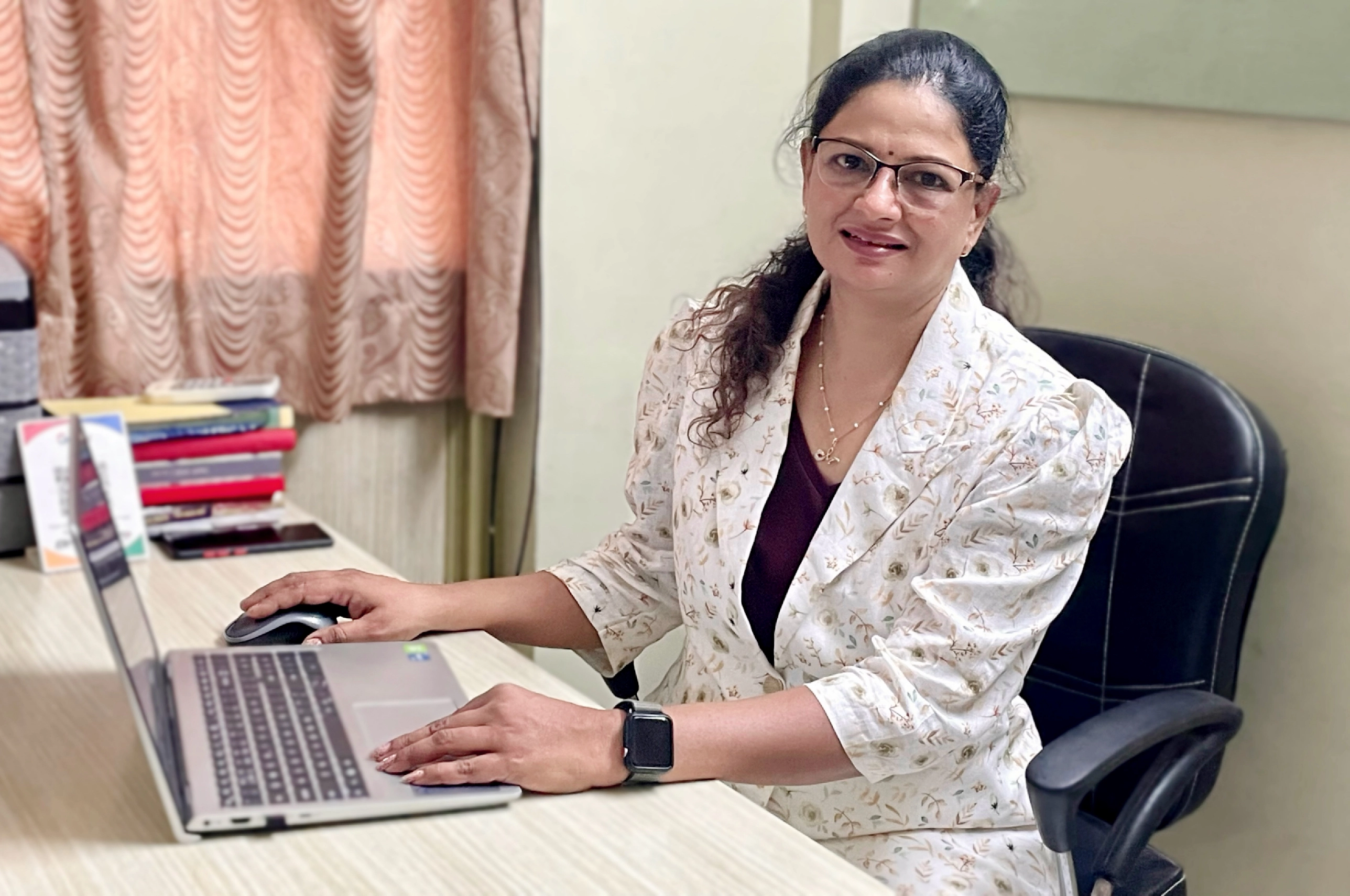 photo of the founder sitting in their office with a laptop